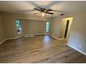 Bright main bedroom with new laminate flooring, ceiling fan, and windows allowing natural light at 726 Chevy Chase St, Port Charlotte, FL 33948