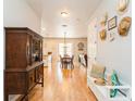 Open entryway with hardwood floors, a bench, and a view of the dining area at 7424 Acorn Blvd, Punta Gorda, FL 33982