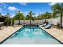 Inviting backyard pool area with ample lounging space and a privacy fence at 7424 Acorn Blvd, Punta Gorda, FL 33982