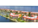 Panoramic aerial view of waterfront condos with terracotta roofs and lush landscaping at 90 Vivante Blvd # 202, Punta Gorda, FL 33950