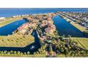 Breathtaking aerial view of the community, showcasing waterways, condos, and manicured landscaping at 90 Vivante Blvd # 202, Punta Gorda, FL 33950