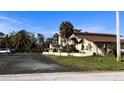 Beautiful exterior of the home showcasing the inviting porch, and mature trees at 93 Boundary Blvd # 303, Rotonda West, FL 33947
