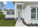 Welcoming front entrance featuring a modern door with glass panels and stone accents at 165 Ingram Blvd, Rotonda West, FL 33947