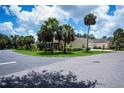 Home exterior featuring the front entrance, screened-in lanai and a two-car garage at 1318 Red Oak Ln, Port Charlotte, FL 33948