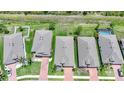 Aerial view of a neighborhood with well-maintained homes, driveways, and manicured lawns at 15261 Mille Fiore Blvd, Port Charlotte, FL 33953