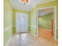 Light-filled entryway featuring tile flooring and a glass paneled front door at 1527 Aqui Esta Dr # 3, Punta Gorda, FL 33950
