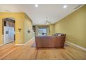 Open living room with hardwood floors, recessed lighting, and seamless flow to the kitchen at 1527 Aqui Esta Dr # 3, Punta Gorda, FL 33950