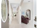 Warm and welcoming foyer with archways, tile flooring, and a comfortable sitting area at 167 & 169 Marker Rd, Rotonda West, FL 33947