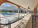 A covered patio looks out to a screened-in pool area, enhancing outdoor living and enjoyment at 2131 Heasley Rd, Englewood, FL 34223