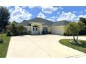 Charming home with mature landscaping, a spacious driveway, and an attached garage at 2244 Mauritania Rd, Punta Gorda, FL 33983