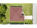 Aerial view of a house with a well-maintained dark roof and a large green lawn at 23101 Hillsdale Ave, Port Charlotte, FL 33954