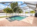 Screened-in pool area with a brick paver deck, providing a perfect outdoor space for relaxation and recreation at 2373 Chartwell Ave, North Port, FL 34288