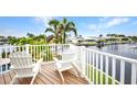 Relaxing patio with two white chairs overlooking the tranquil waterfront at 250 Freeport Ct, Punta Gorda, FL 33950