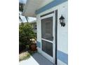 Side entrance featuring a security door and an outdoor light fixture at 26312 Deep Creek Blvd, Punta Gorda, FL 33983