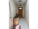 Inviting foyer with a decorative cabinet, tile flooring, and a charming front door with a half-moon window at 26312 Deep Creek Blvd, Punta Gorda, FL 33983