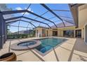 The screened-in pool area features a spa, lounge area, and private backyard oasis perfect for relaxation and entertaining at 264 Rotonda N Blvd, Rotonda West, FL 33947