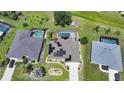 An overhead view of a home featuring solar panels, a pool and lush green surroundings in a serene neighborhood at 37 Pepe Ct, Punta Gorda, FL 33983