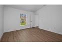 Well-lit bedroom with wood flooring and a window overlooking the backyard at 49 Troutdale St, Port Charlotte, FL 33954