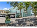 Turquoise condo building showing covered parking, landscaping, and proximity to the bay at 53 W Bay Heights Rd # 307, Englewood, FL 34223
