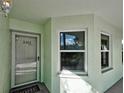 Charming entrance featuring a screen door, house number, and welcoming 'HOME' doormat at 5725 Greenwood Ave # 5103, North Port, FL 34287