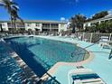 Refreshing community pool surrounded by lounge chairs and white fencing for ultimate relaxation at 5725 Greenwood Ave # 5103, North Port, FL 34287