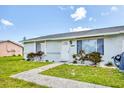 Attractive single-story home with a vibrant green lawn, sidewalk, and inviting front entrance at 5983 Hobhill Ave, North Port, FL 34287
