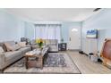 Cozy living room with plush seating, front door, neutral color palette, and lots of natural light at 5983 Hobhill Ave, North Port, FL 34287