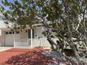 Inviting home with brick front porch and mature trees adding character and charm at 617 W Olympia Ave, Punta Gorda, FL 33950
