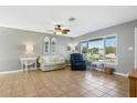 Open living space with tile flooring, a ceiling fan, and large windows for lots of natural light at 6382 Cutler Ter, Port Charlotte, FL 33981