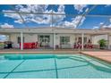 Relaxing outdoor pool area featuring a covered patio with comfortable seating at 871 Columbia St, Port Charlotte, FL 33948