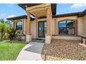 Inviting front porch with stone columns and a landscaped garden at 1275 Blue Lake Cir, Punta Gorda, FL 33983