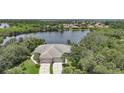 Aerial view of home, showcasing its proximity to a scenic lake and lush landscaping at 14311 Reserve Ct, Port Charlotte, FL 33953