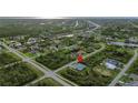 Aerial view showcasing the home's location in a residential area, near canals and green spaces at 14520 Edna Cir, Port Charlotte, FL 33981