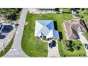 Aerial view of a single-story home with well-maintained landscaping and a metal roof at 15117 Lyneburg Ave, Port Charlotte, FL 33981