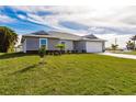 Charming gray single-story home with a well-manicured lawn and lovely landscaping at 16403 Perdida Ct, Punta Gorda, FL 33955