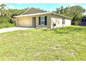 Single story home featuring a well-manicured lawn and a two-car garage at 17344 York Ave, Port Charlotte, FL 33948