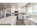 Bright kitchen featuring white cabinets, stainless steel appliances, and a large island with quartz countertops at 175 Rodgers Ne Ave, Port Charlotte, FL 33952