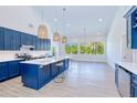 Bright kitchen features a large island, modern appliances, and plenty of natural light from the expansive windows at 18610 Fort Smith Cir, Port Charlotte, FL 33948