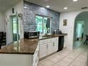 Well-equipped kitchen with granite countertops and modern stainless steel appliances at 21287 Birwood Ave, Port Charlotte, FL 33954