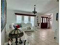 Spacious living room with a contemporary white leather sofa and elegant interior design at 21287 Birwood Ave, Port Charlotte, FL 33954