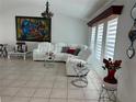Bright living room featuring a modern white leather sectional sofa and stylish decor at 21287 Birwood Ave, Port Charlotte, FL 33954