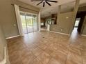 Open-concept living room with tile flooring and sliding glass doors at 2143 Santonian Ter, North Port, FL 34286