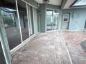 Covered patio with brick flooring and multiple sliding glass doors for indoor-outdoor living at 2143 Santonian Ter, North Port, FL 34286