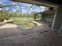 Screened-in pool and patio area overlooking the lawn at 2143 Santonian Ter, North Port, FL 34286