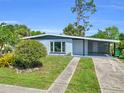 Single-story home featuring a covered carport, driveway, and landscaped front yard at 22219 Catherine Ave, Port Charlotte, FL 33952