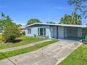 A single-story home featuring a covered carport and driveway leading to a well-maintained lawn at 22219 Catherine Ave, Port Charlotte, FL 33952