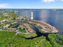 Stunning aerial view of waterfront homes with boat docks and surrounding landscaping and beautiful water views at 25188 Marion Ave # 45, Punta Gorda, FL 33950