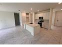 Modern kitchen with an island, stainless steel appliances, and sleek cabinetry at 2534 Longworthy Rd, North Port, FL 34288