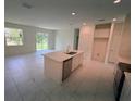 Open-concept kitchen with island, modern appliances, and plenty of counter space at 2534 Longworthy Rd, North Port, FL 34288
