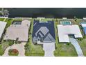 Aerial view of a single-Gathering home featuring a modern roof, tidy landscaping, and canal access at 2815 Coral Way, Punta Gorda, FL 33950